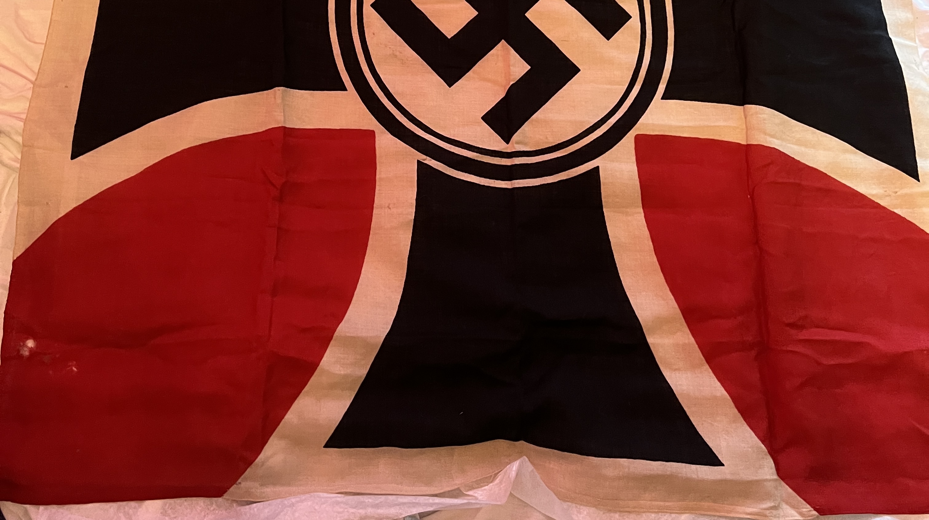 black swastika on white field within black Iron Cross upon red background